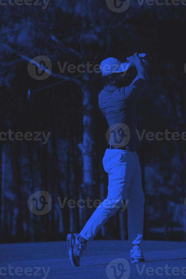 golf player hitting long shot photo