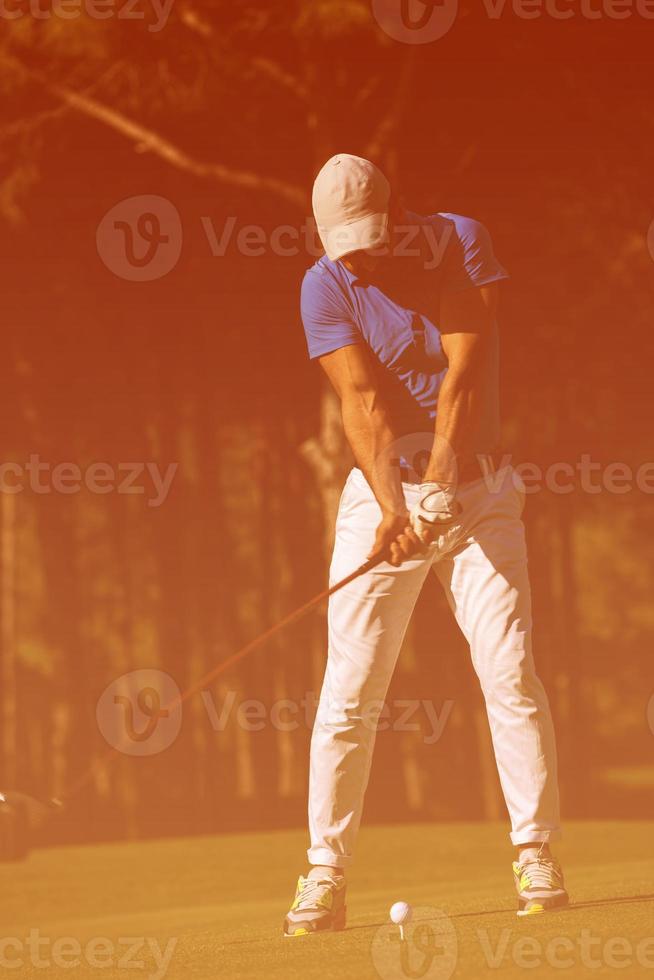 golf player hitting shot photo