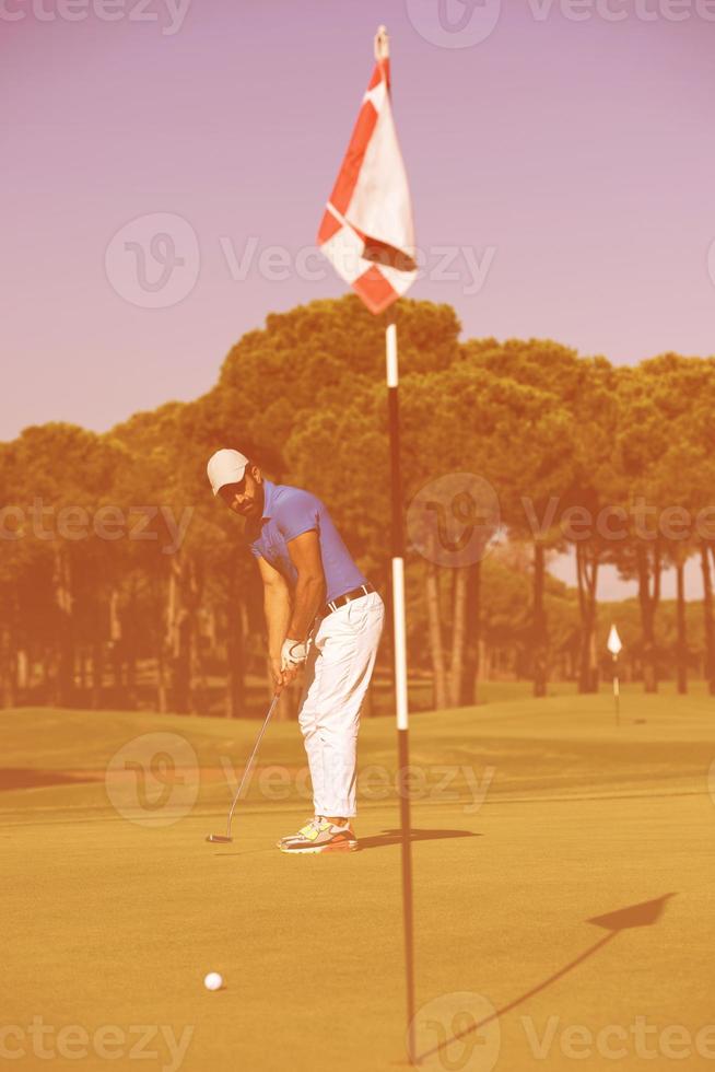 golf player hitting shot at sunny day photo