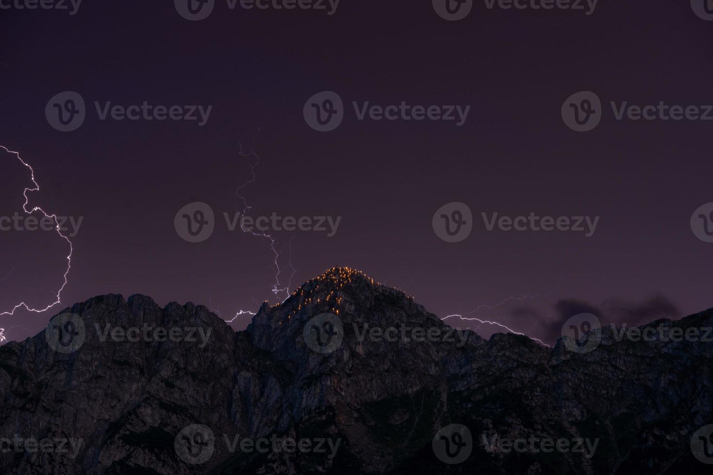 Mountain illuminated by lightning photo