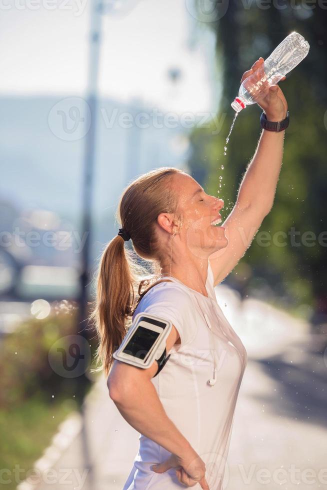 woman drinking  water after  jogging photo