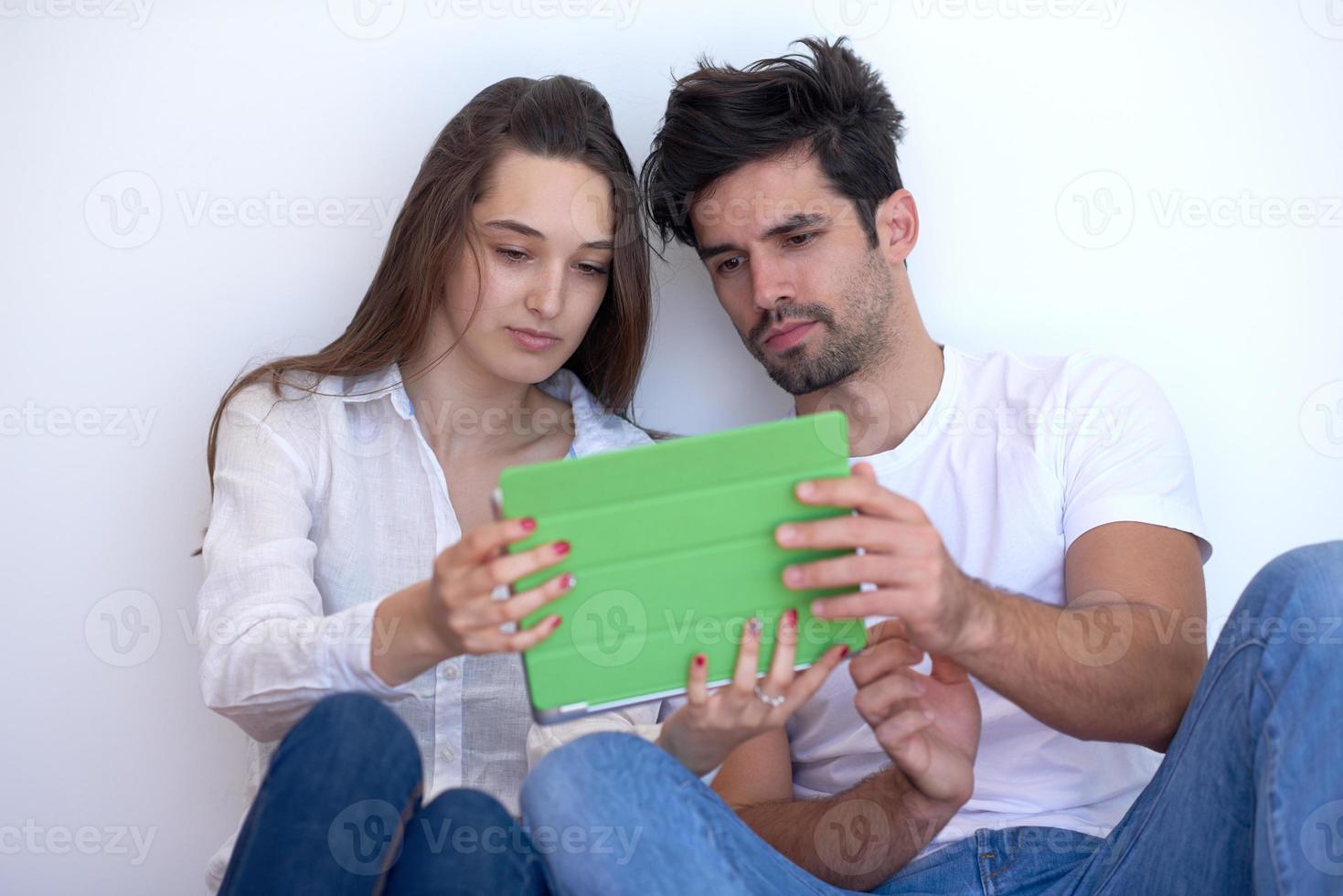couple at modern home using tablet computer photo