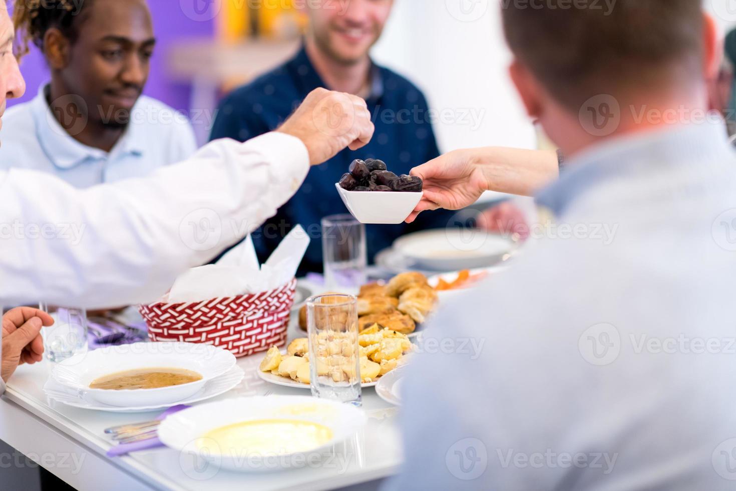 modern multiethnic muslim family sharing a bowl of dates photo