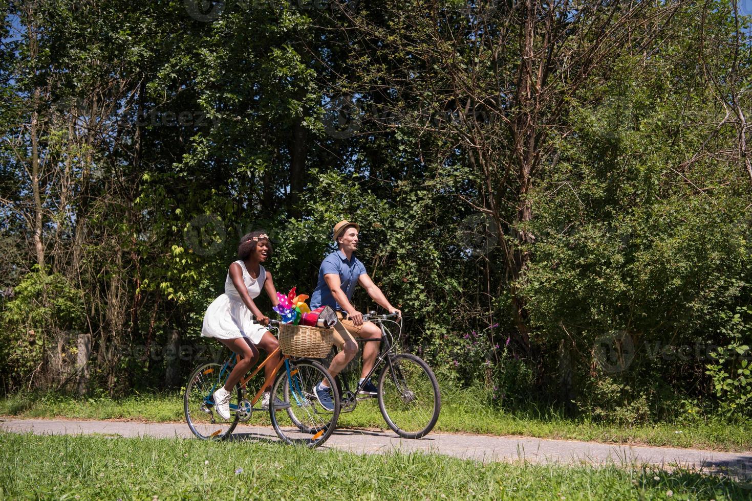 Young multiethnic couple having a bike ride in nature photo