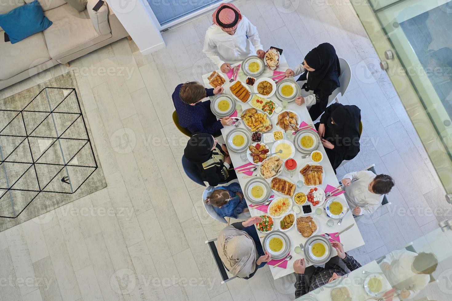 Top view of Muslim family making iftar dua to break fasting during Ramadan. photo