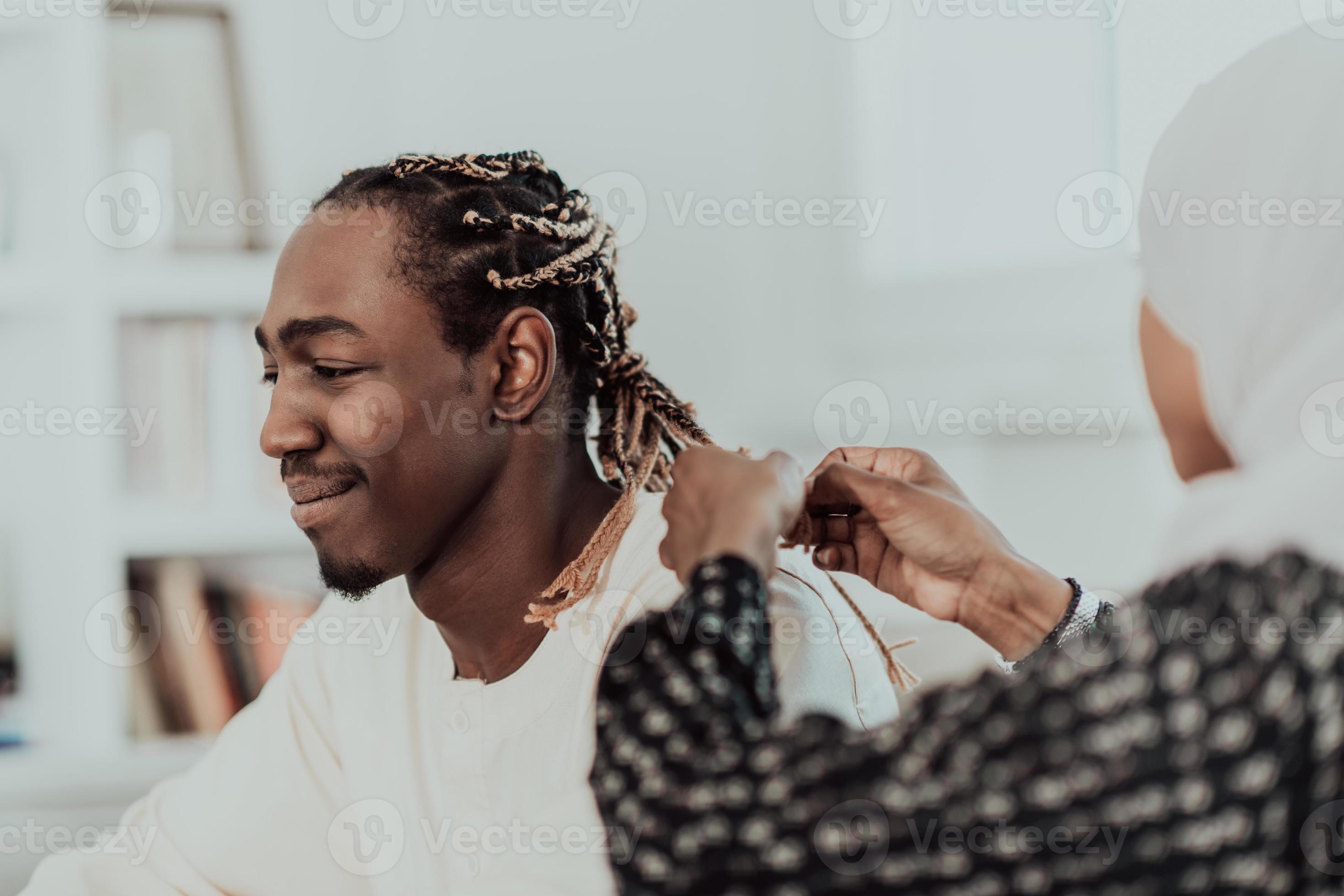 A young Muslim couple has a romantic time at home while the woman makes the  hairstyle for her husband female wearing traditional Sudan Islamic hijab  clothes. 10974273 Stock Photo at Vecteezy
