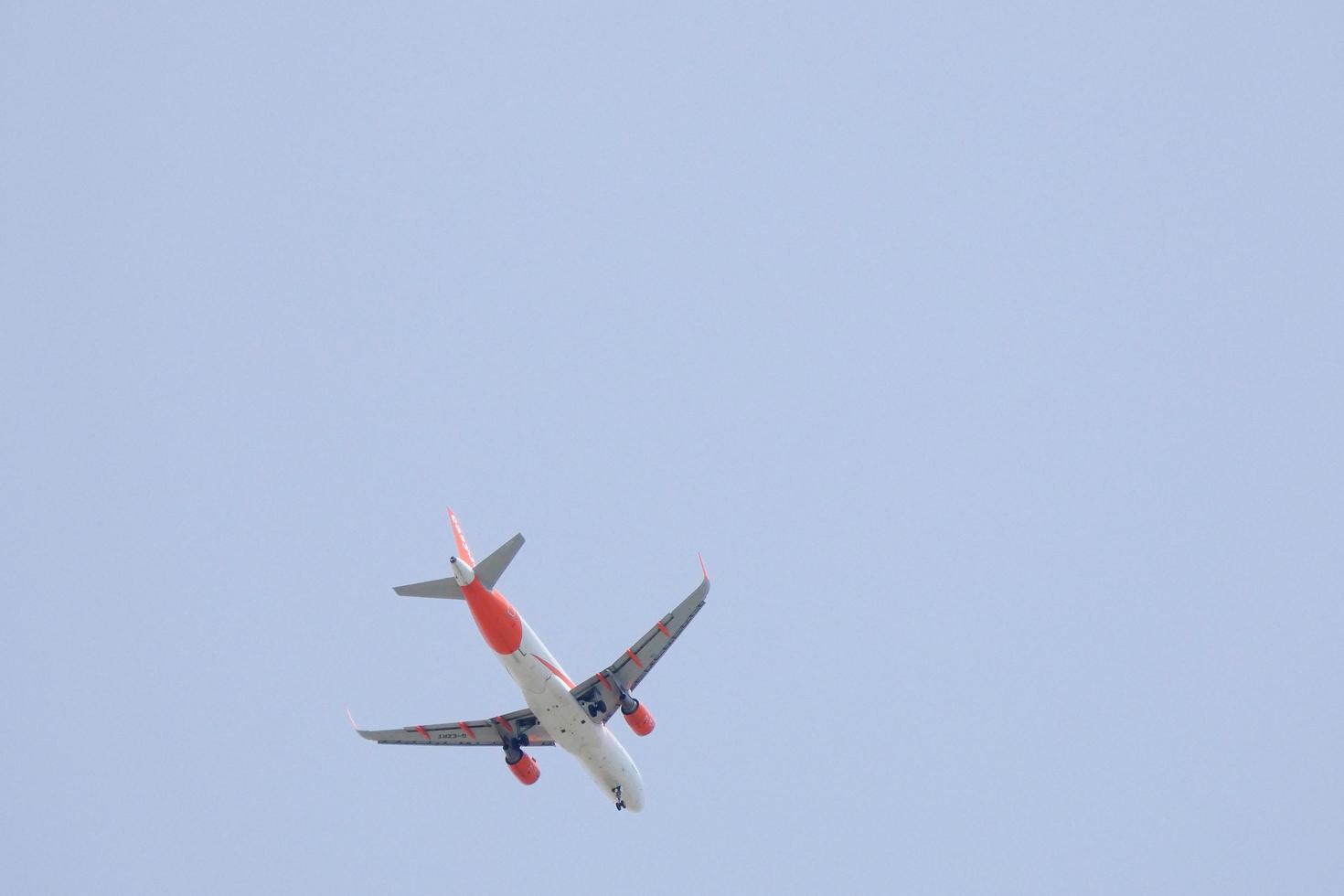 commercial aircraft flying under blue skies and arriving at the airport photo