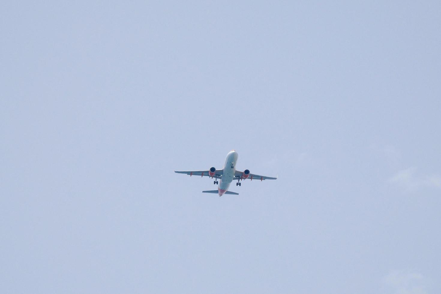 commercial aircraft flying under blue skies and arriving at the airport photo