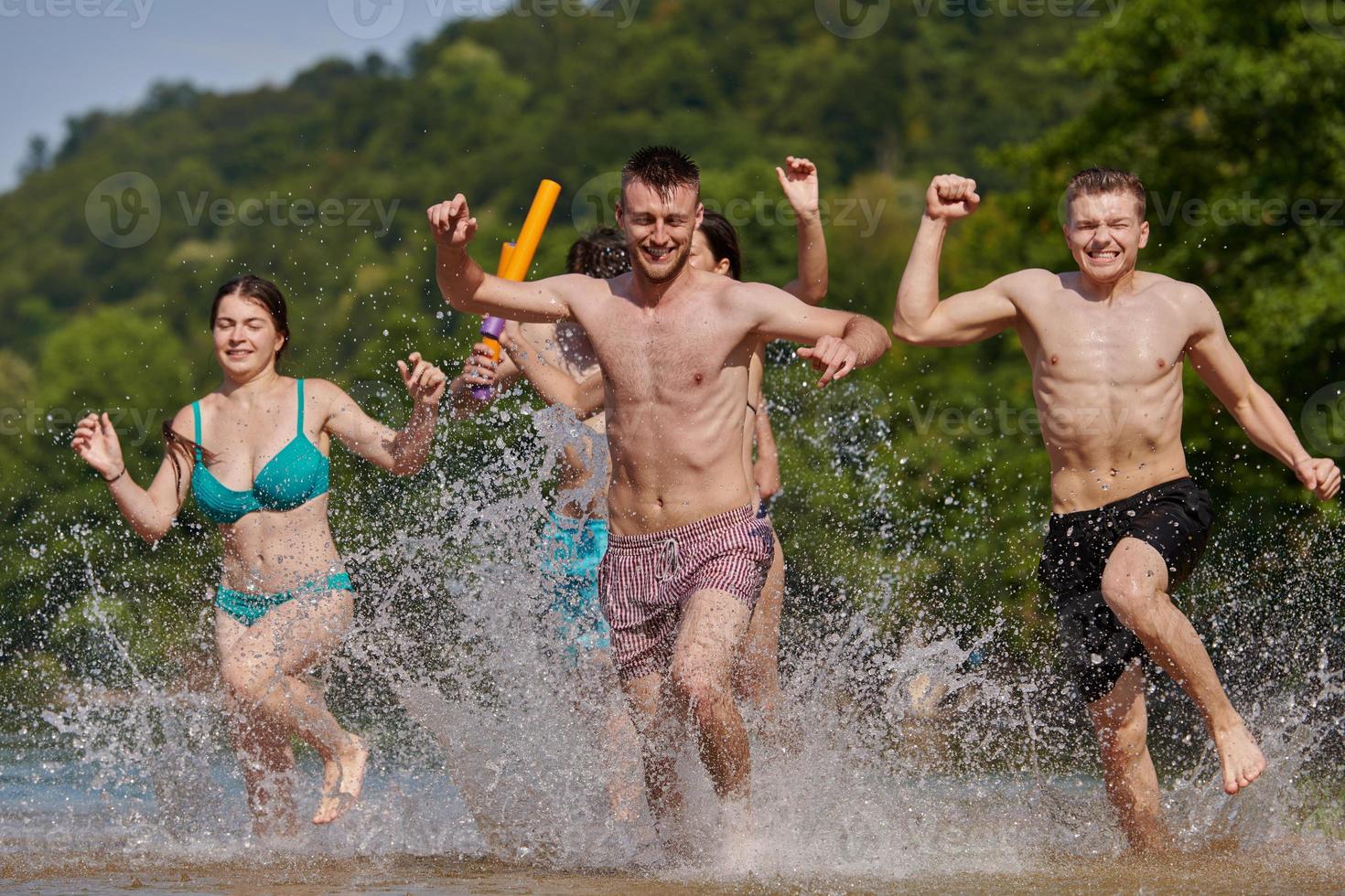 group of happy friends having fun on river photo