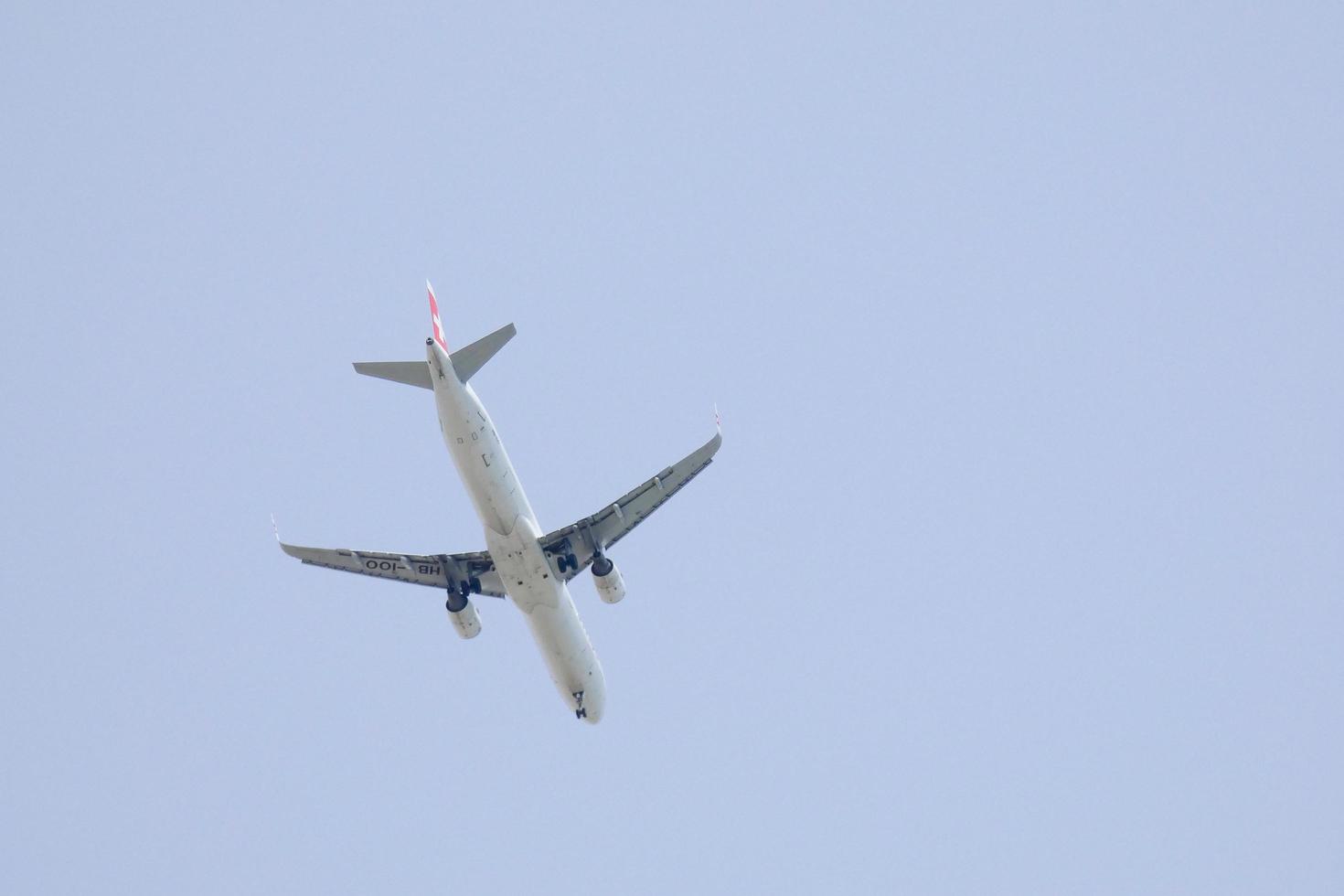 commercial aircraft flying under blue skies and arriving at the airport photo
