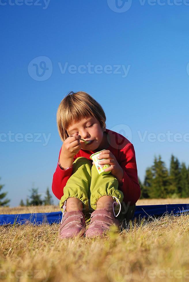 happy girl eating healthy food in nature photo