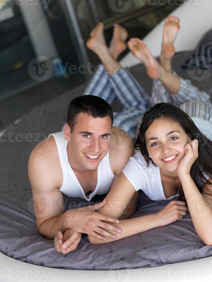 couple relax and have fun in bed photo