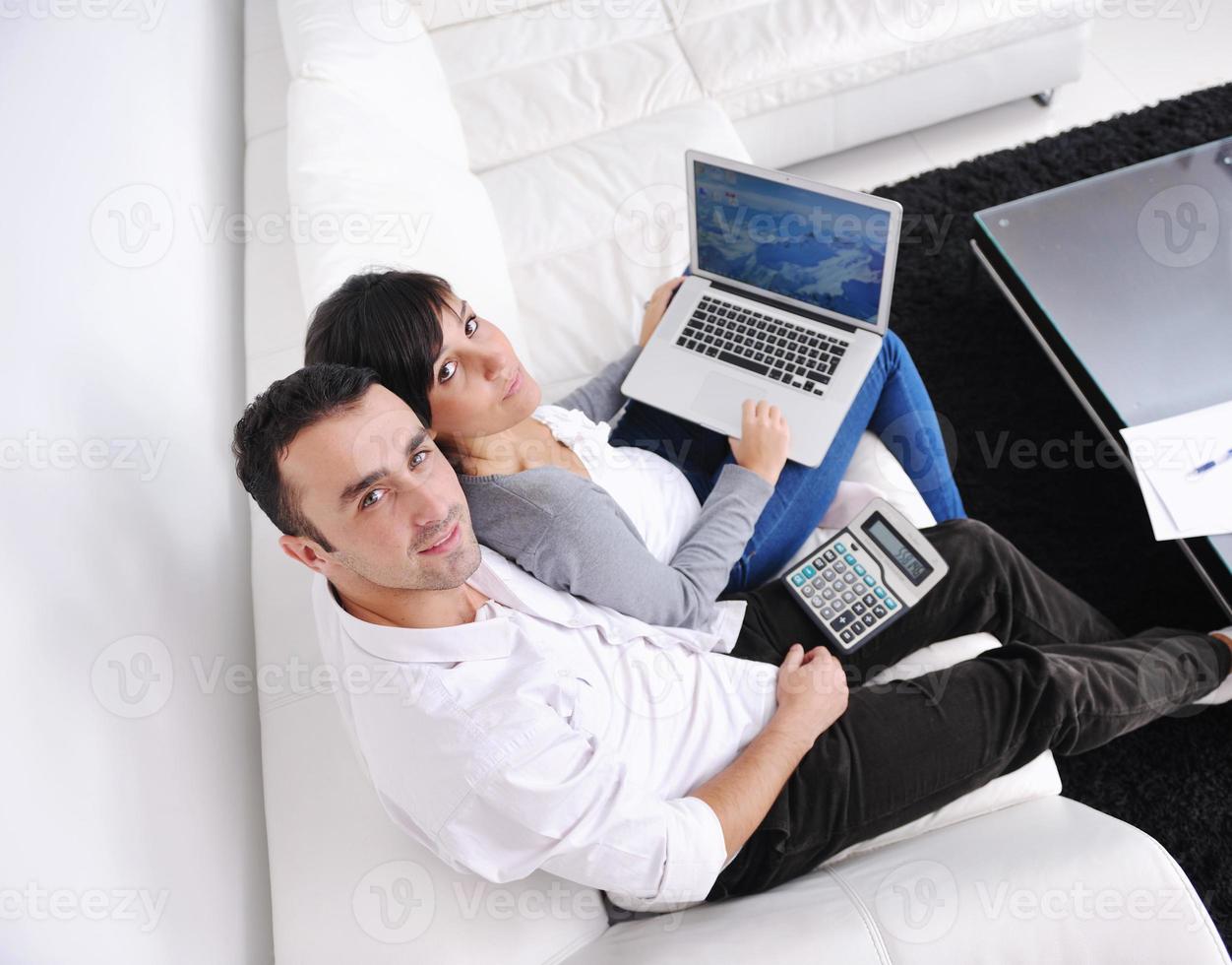 joyful couple relax and work on laptop computer at modern home photo