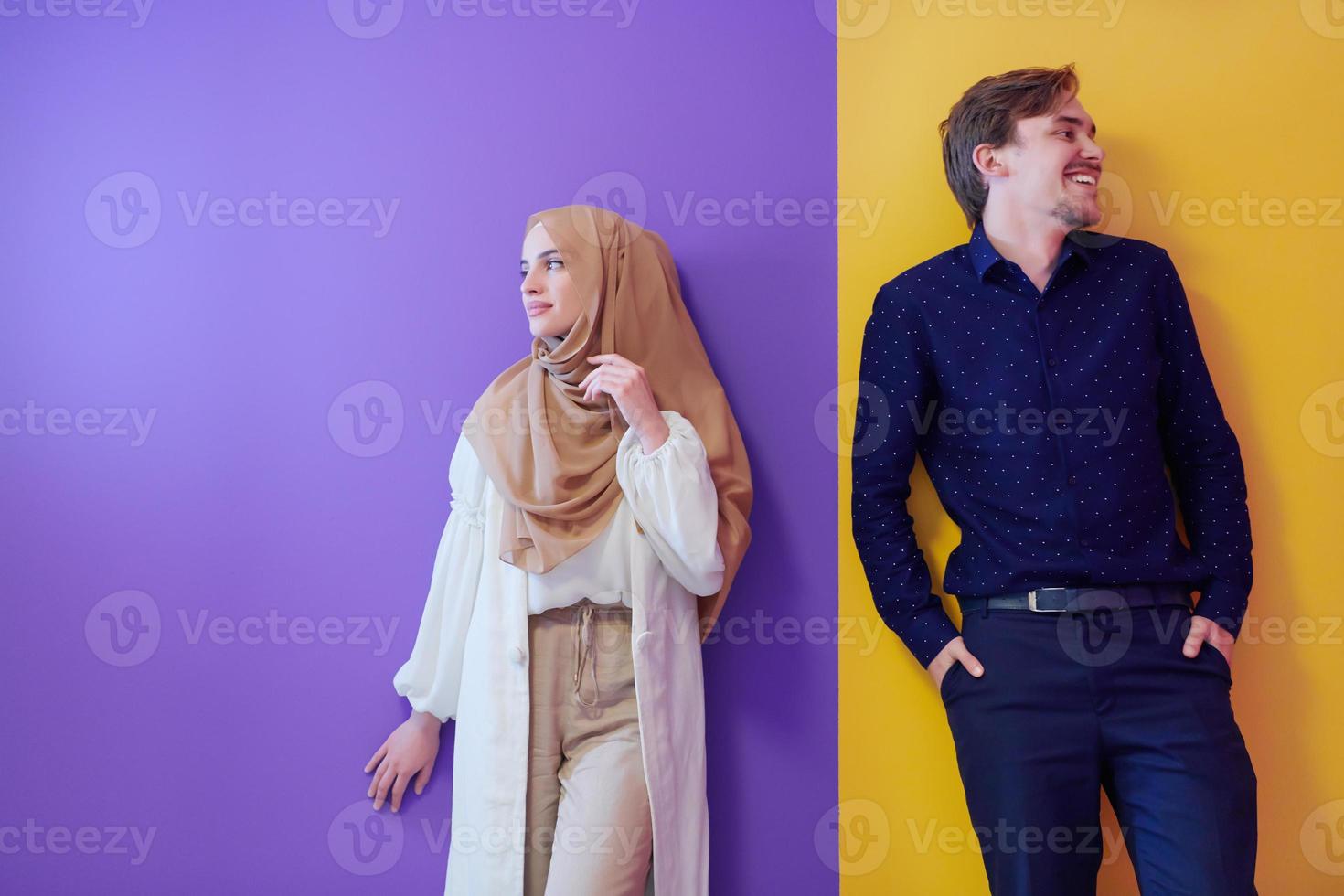 portrait of young muslim couple isolated on colorful background photo