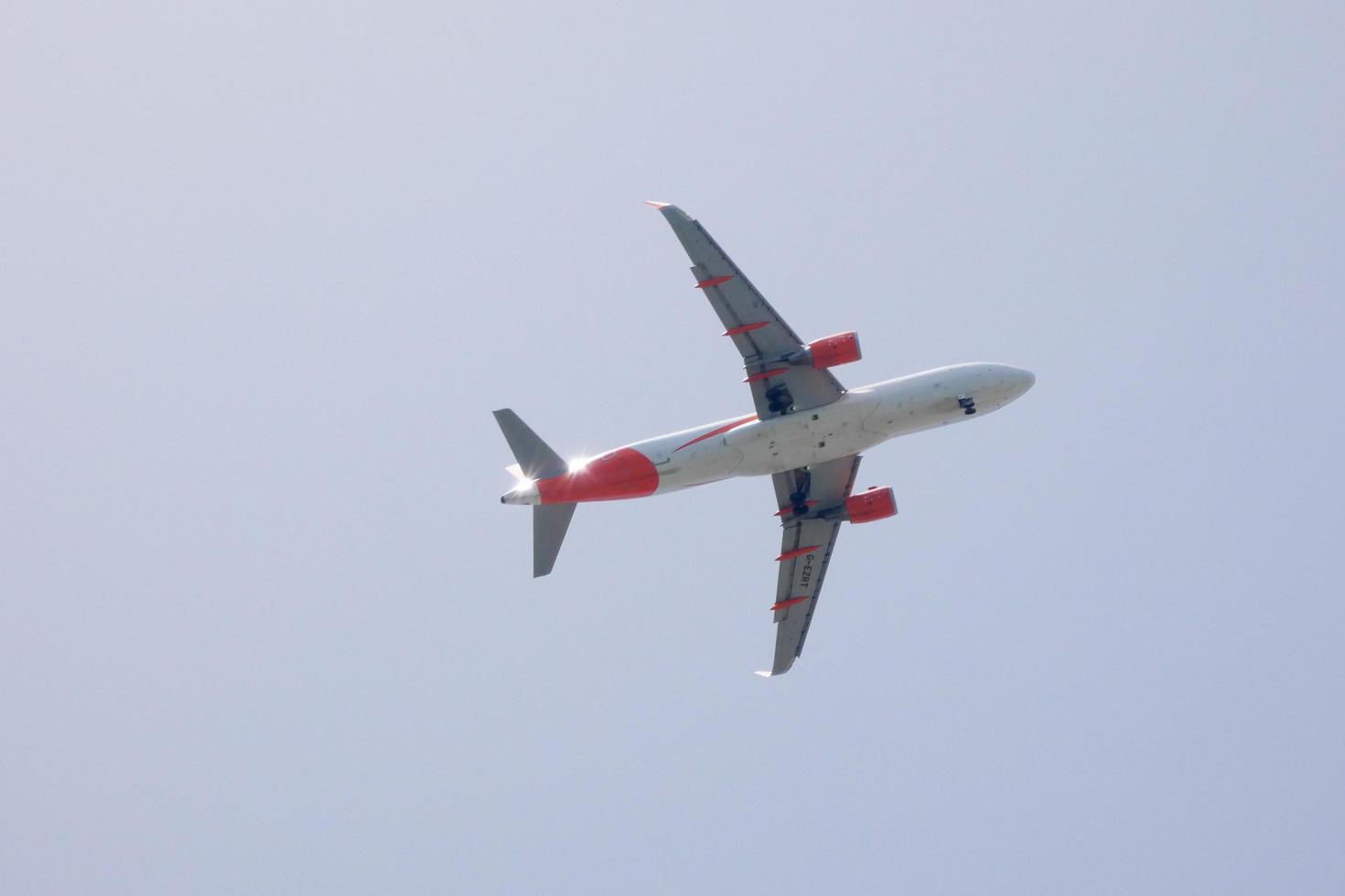 commercial aircraft flying under blue skies and arriving at the airport photo