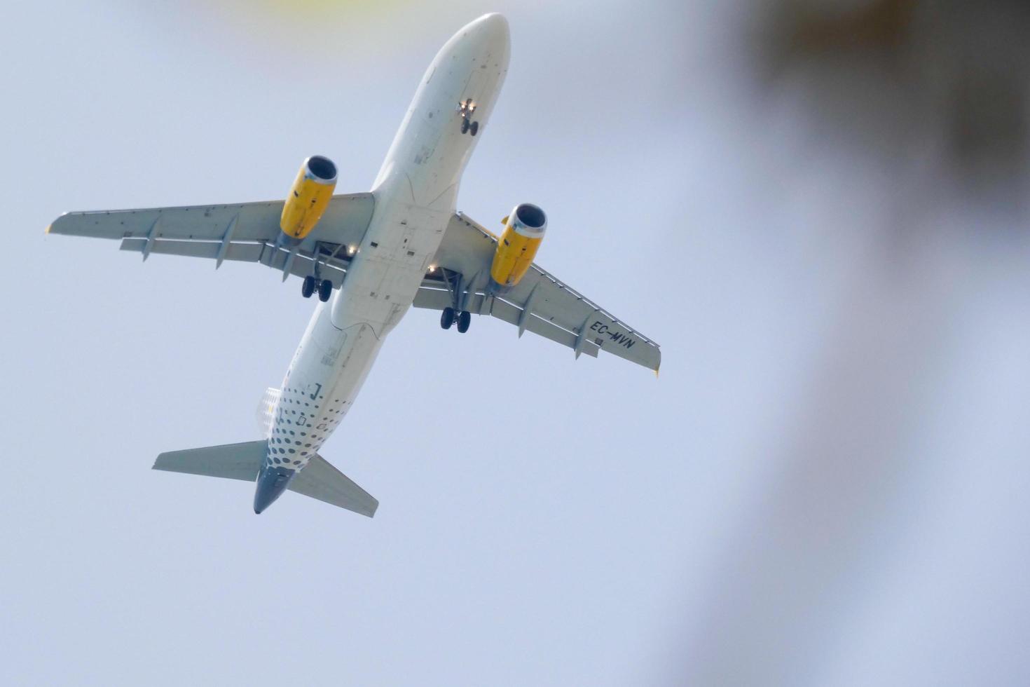 commercial aircraft flying under blue skies and arriving at the airport photo