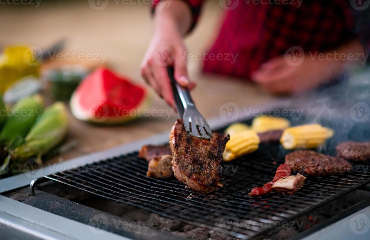 Man cooking tasty food on barbecue grill photo