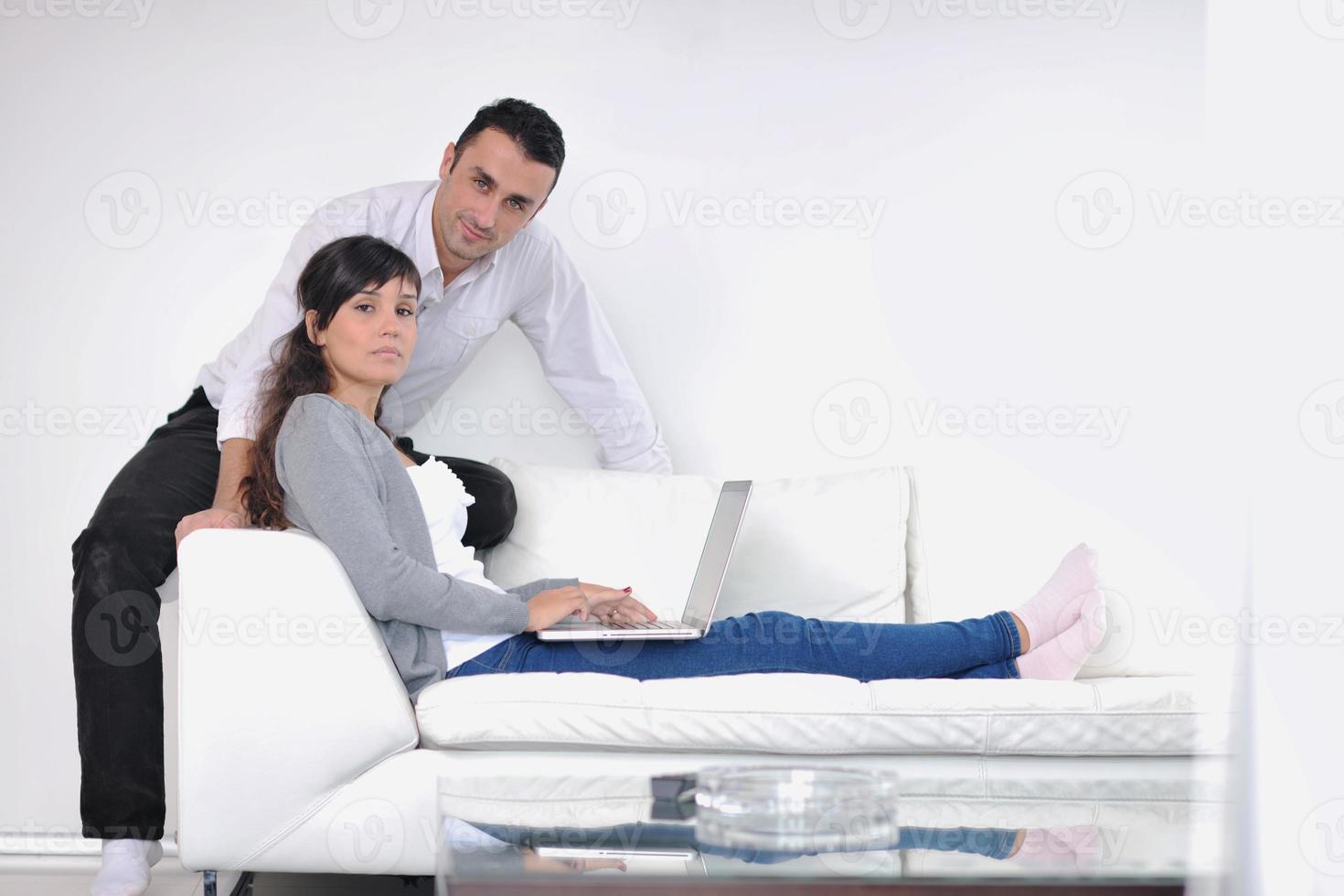 joyful couple relax and work on laptop computer at modern home photo