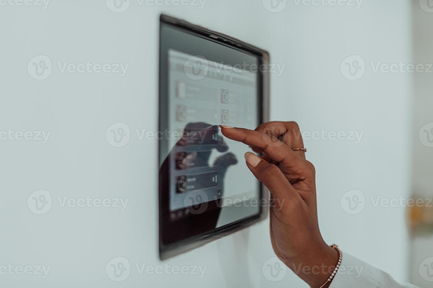 African woman using smart home screen control system photo