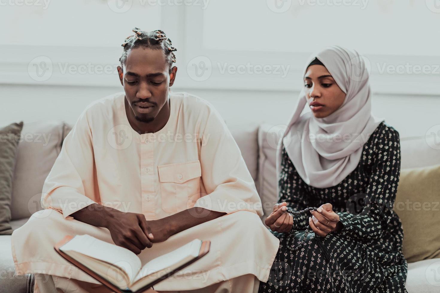 African Muslim couple at home in Ramadan reading Quran holly Islam book.  10975403 Stock Photo at Vecteezy