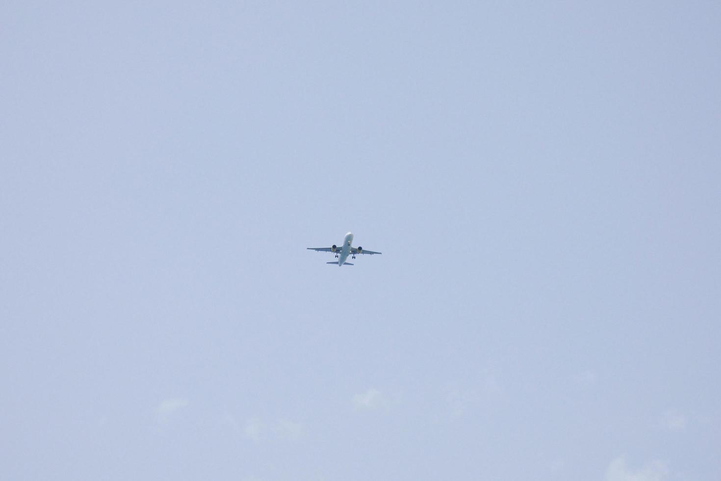 commercial aircraft flying under blue skies and arriving at the airport photo