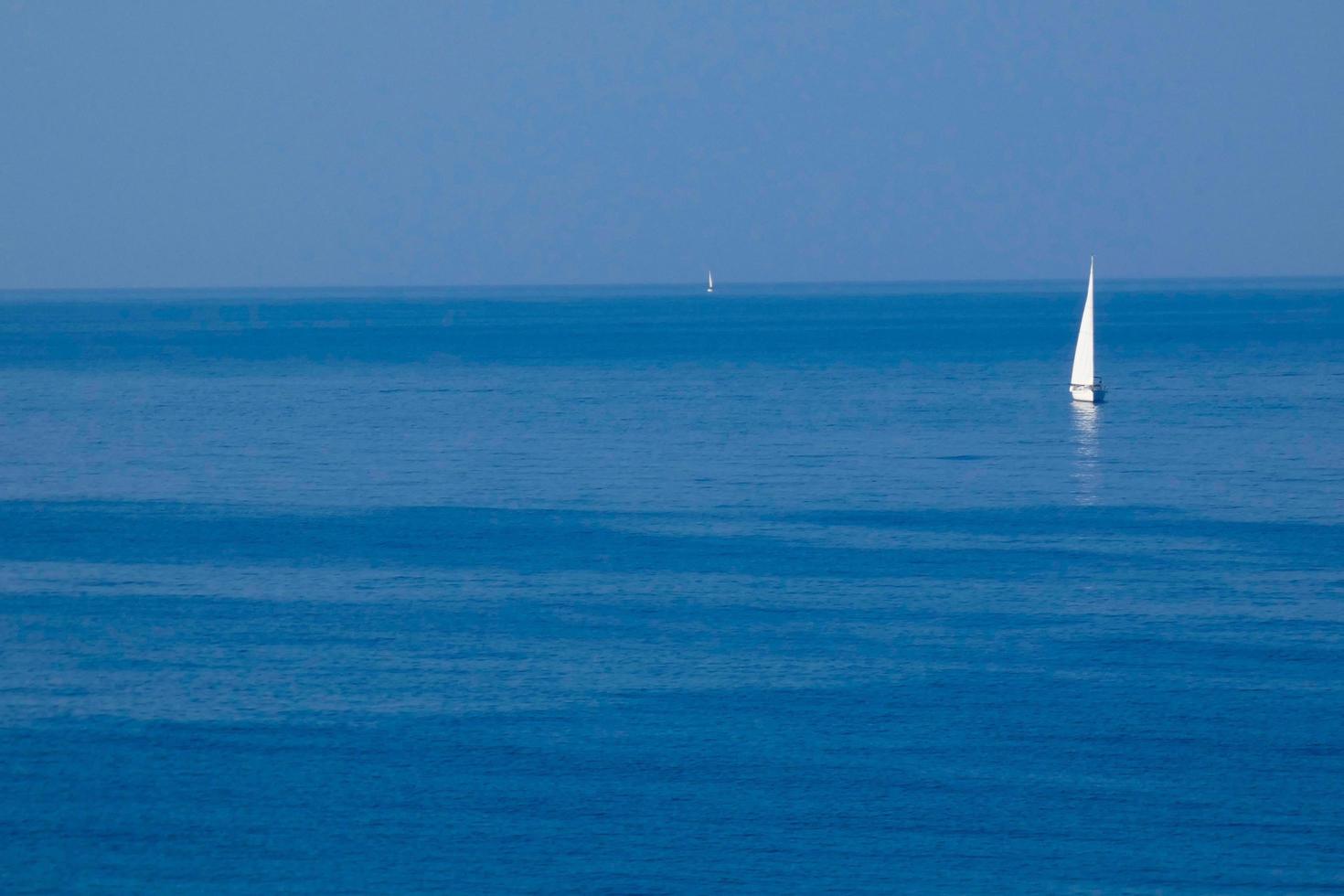 Solitary sailboat on the mediterranean coast of the Catalan Costa Brava photo