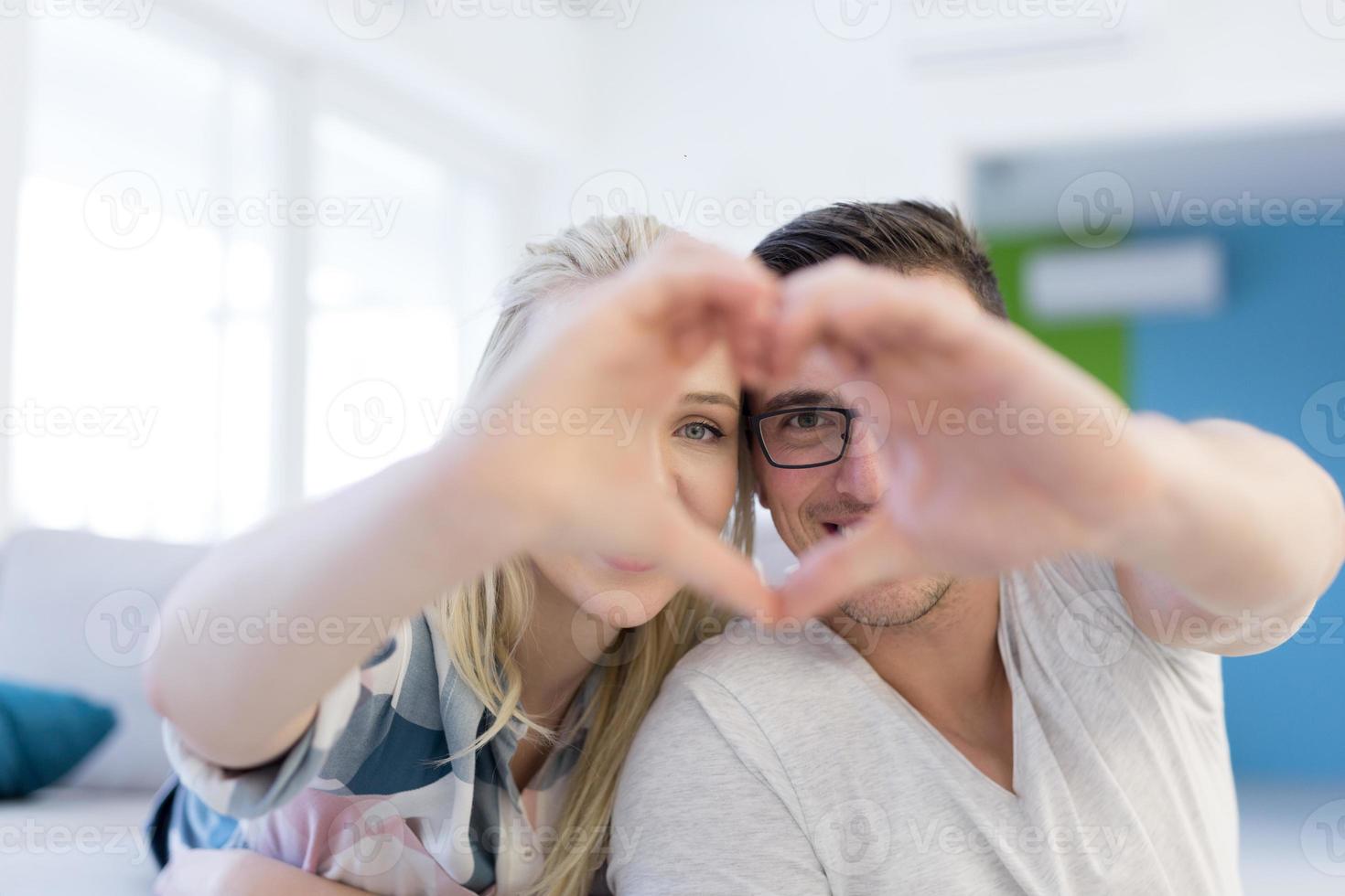 couple making heart with hands photo