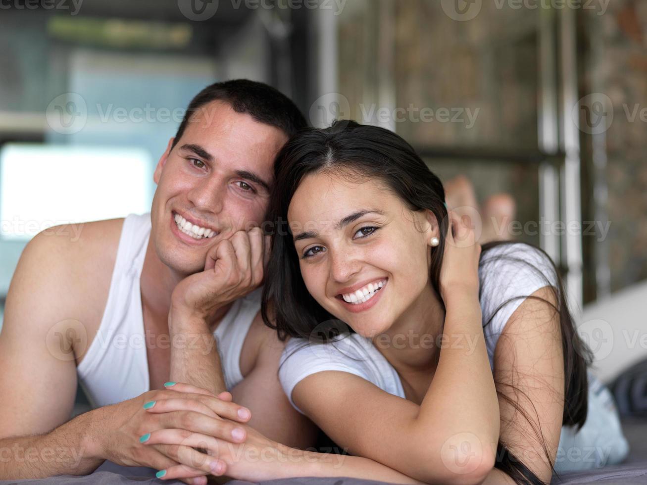 couple relax and have fun in bed photo