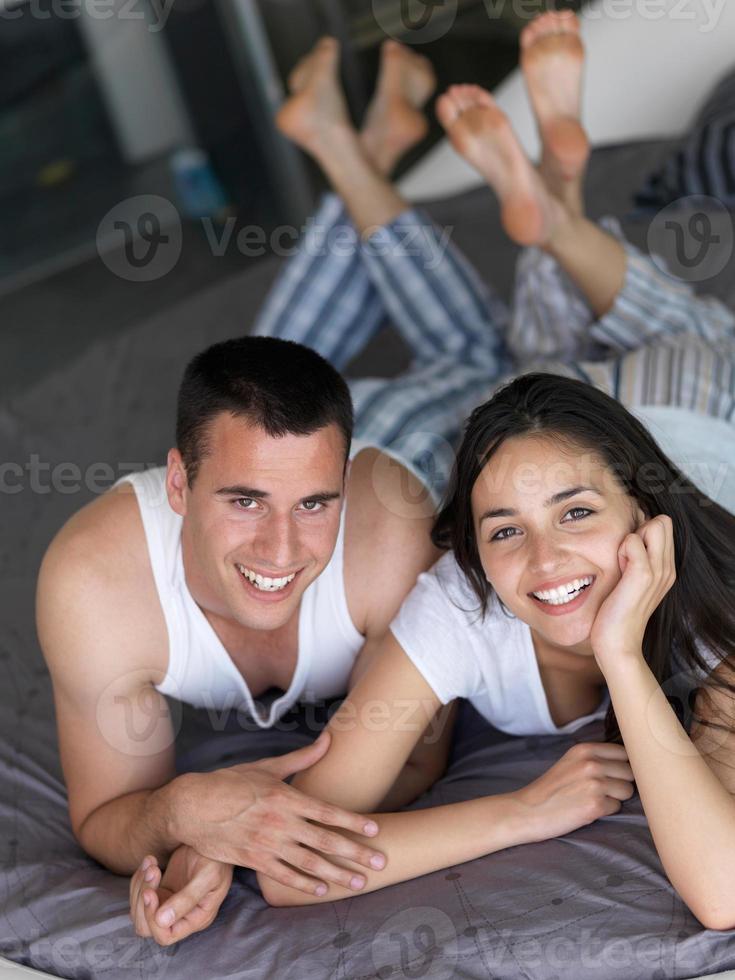 couple relax and have fun in bed photo