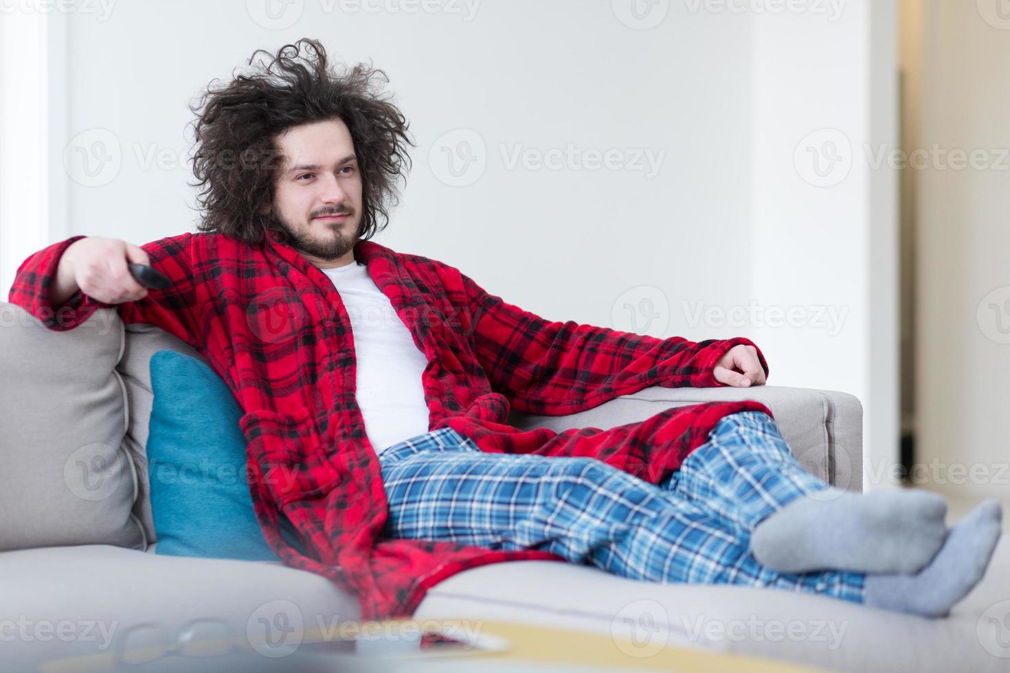 young man in bathrobe enjoying free time photo