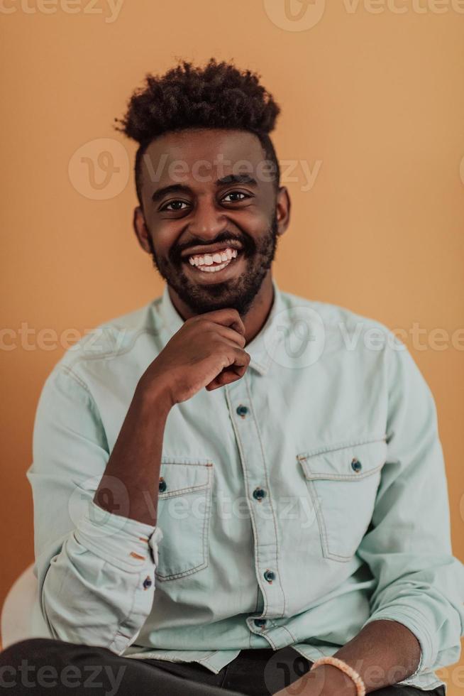 African student using laptop computer to study and make business connections yellow background photo