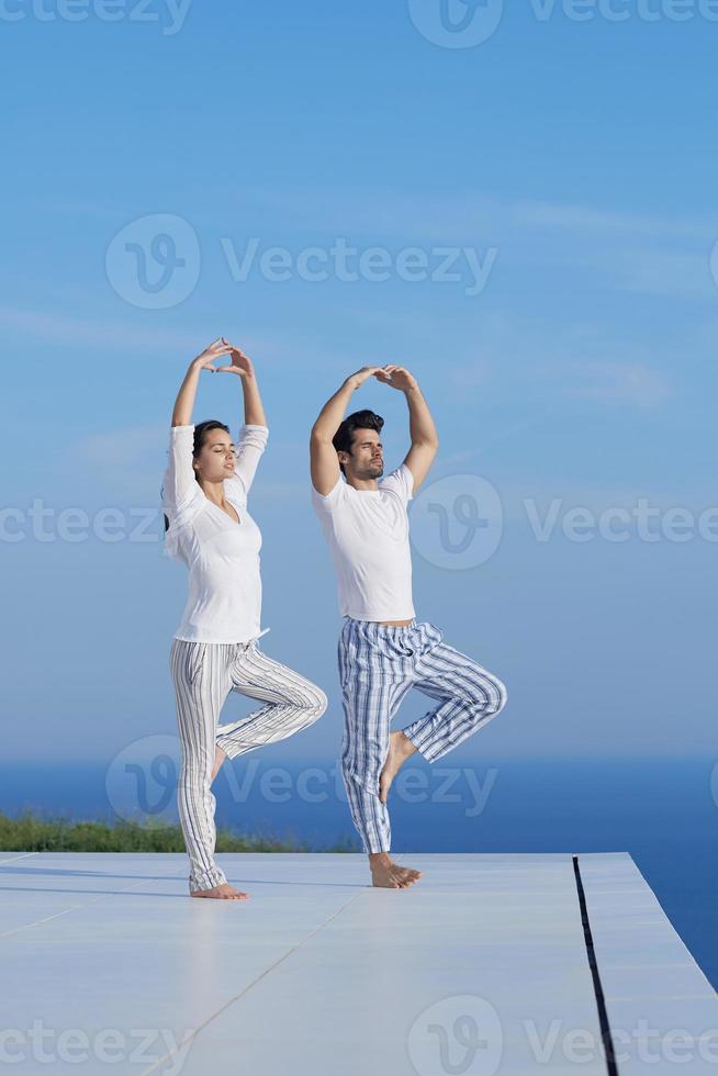 young couple practicing yoga photo