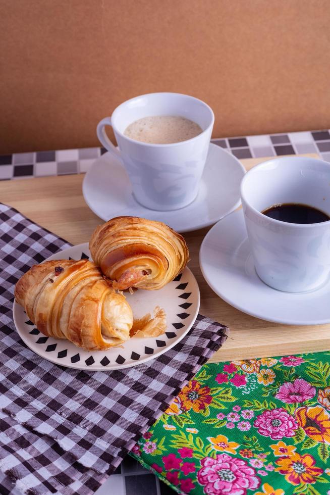 cup of coffee and croissant photo