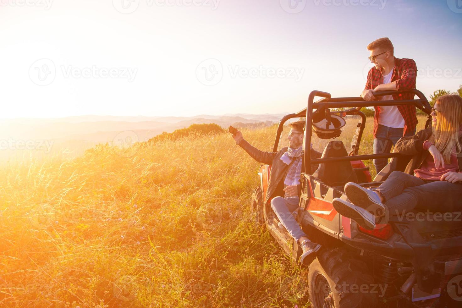group of young people driving a off road buggy car photo