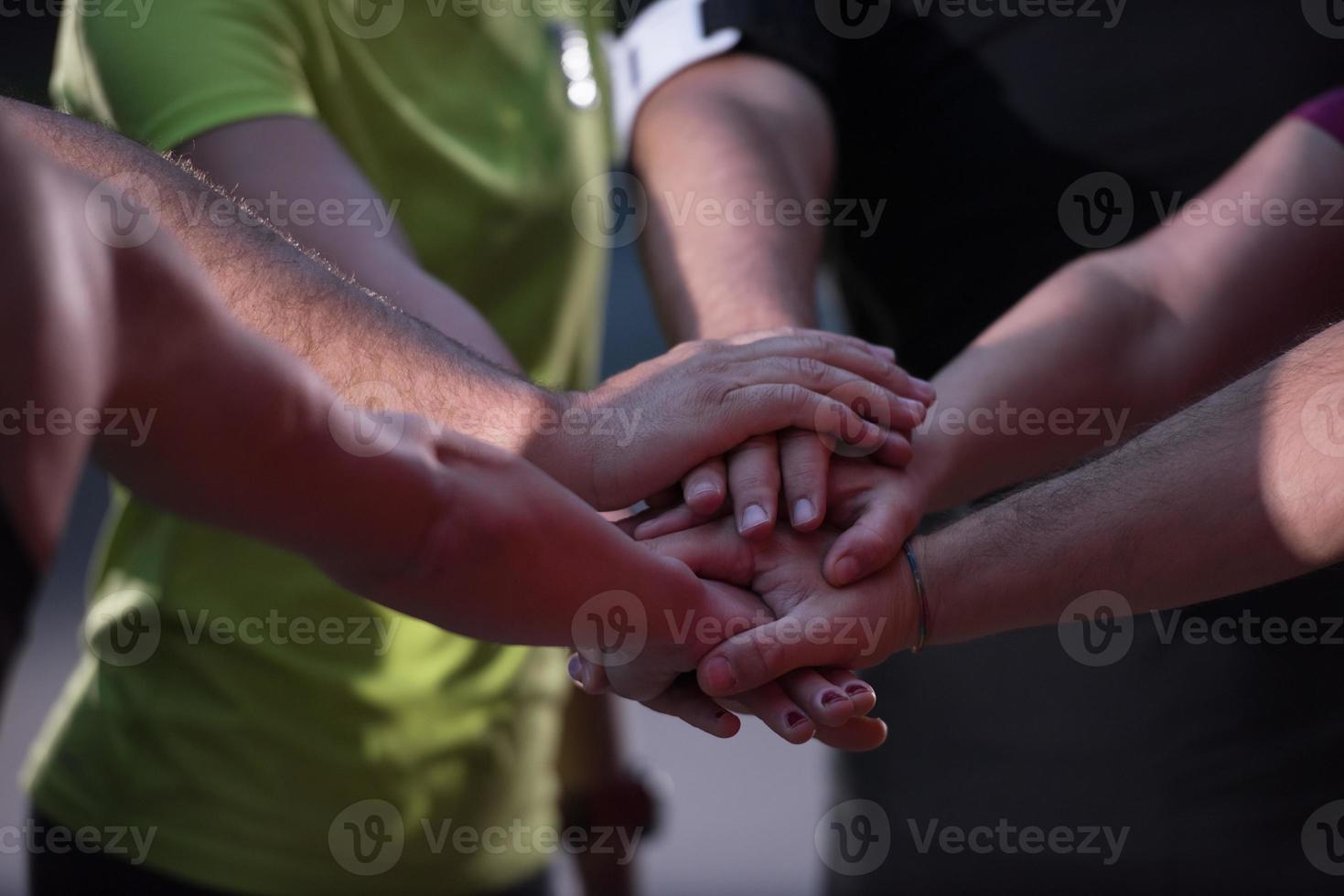 runners giving high five to each other photo
