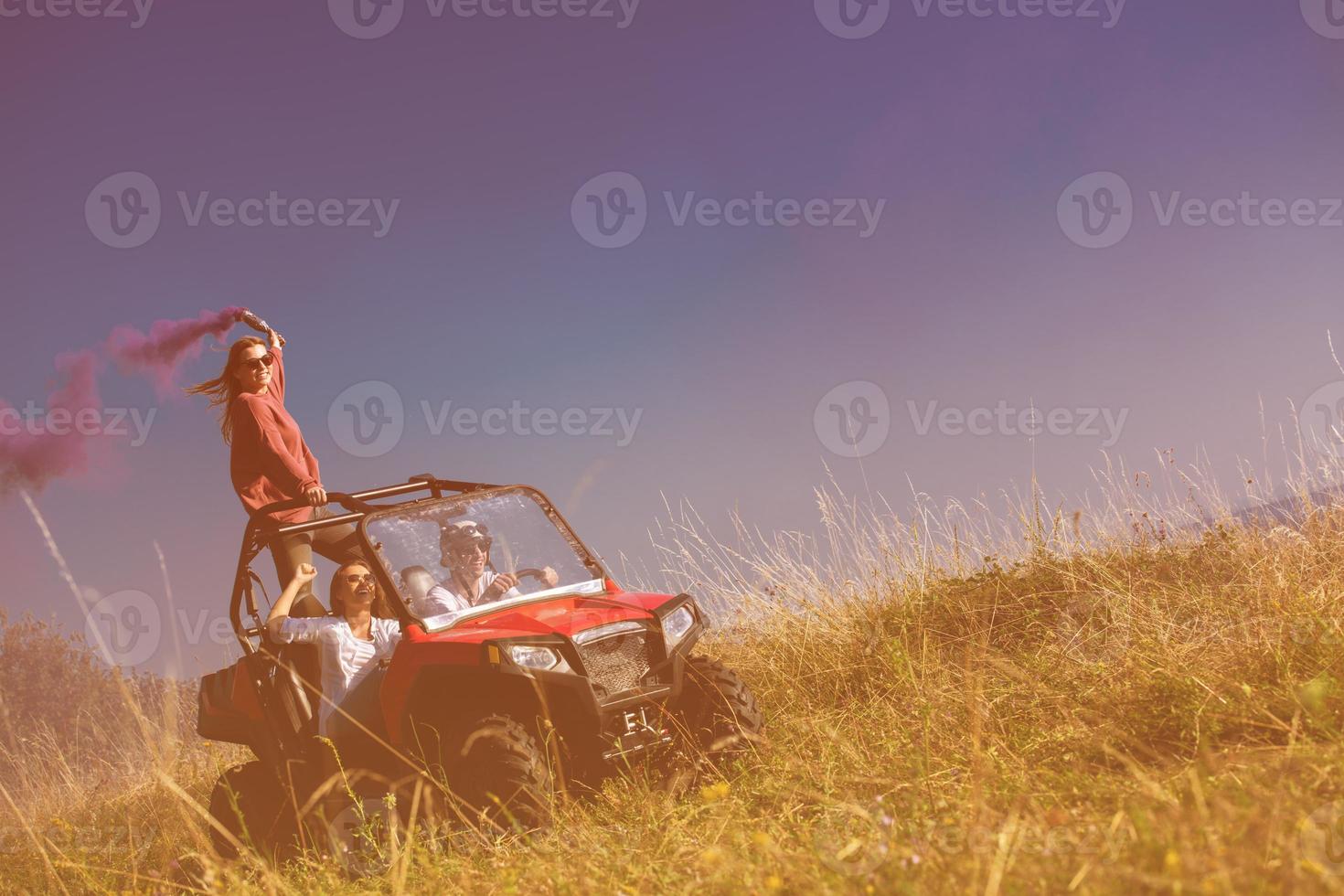 group of young people having fun while driving a off road buggy car photo