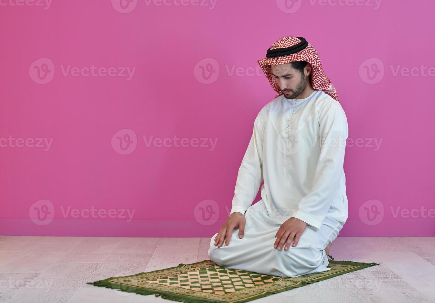 Young muslim man praying salat during Ramadan photo