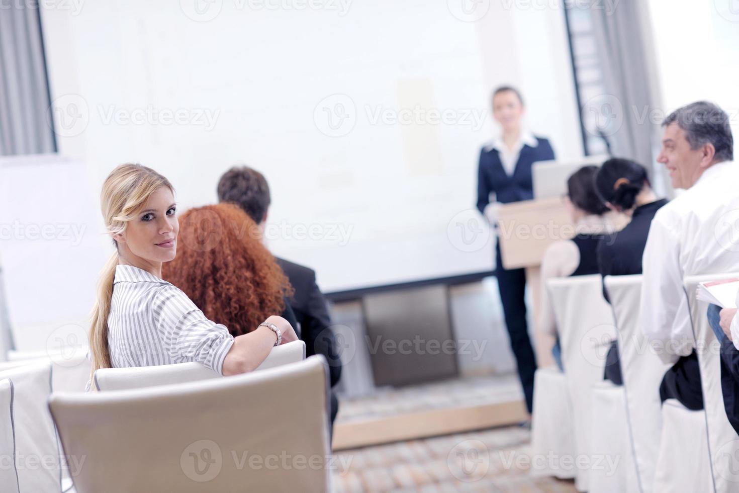 business woman standing with her staff at conference photo