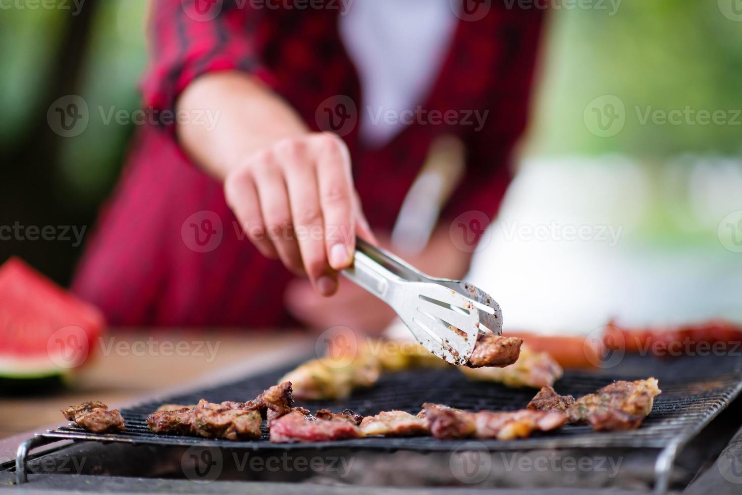 Man cooking tasty food on barbecue grill photo