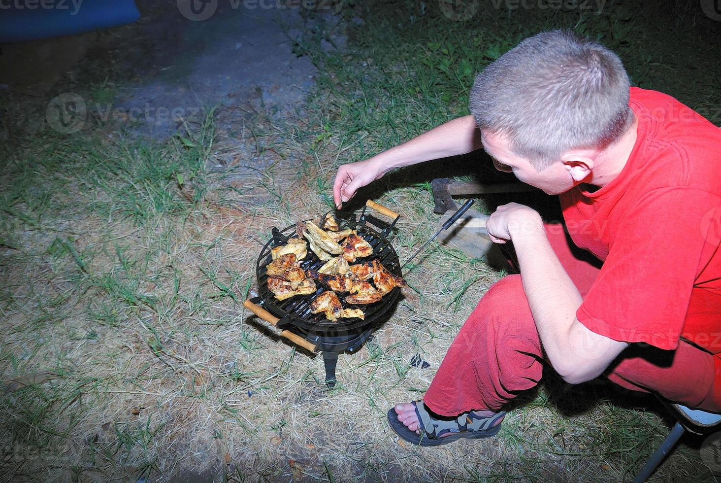 preparing chicken on grill photo