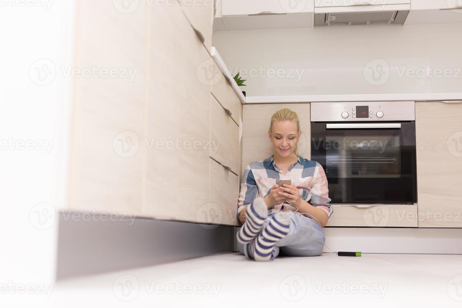 young women using mobile phone at home photo