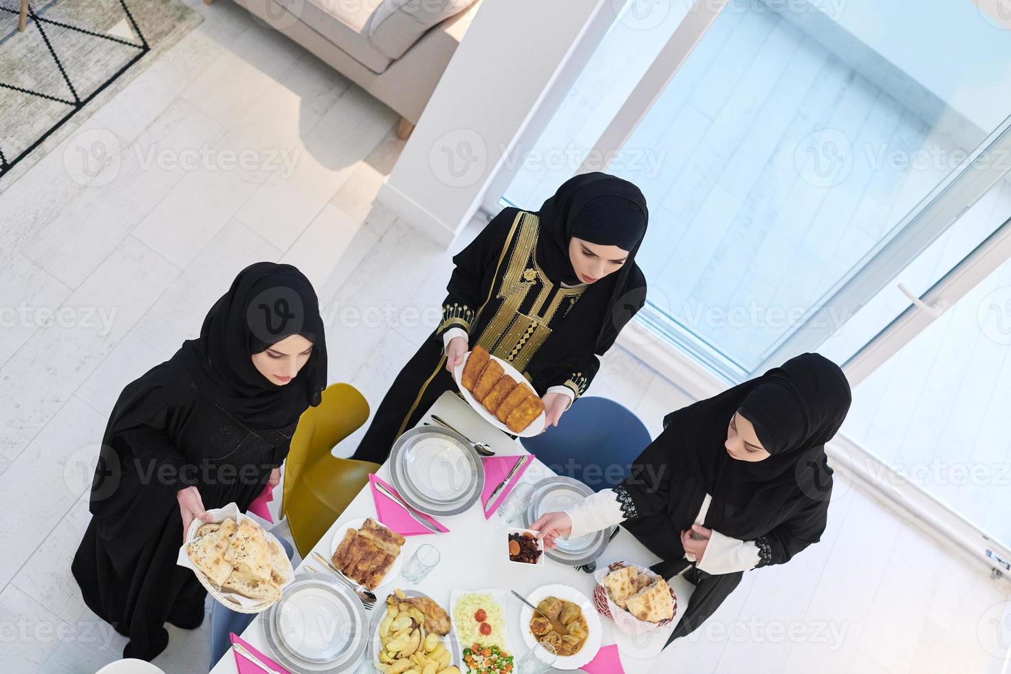 Top view of young muslim women preparing food for iftar during Ramadan photo