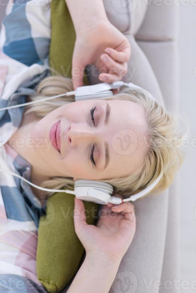 girl enjoying music through headphones photo