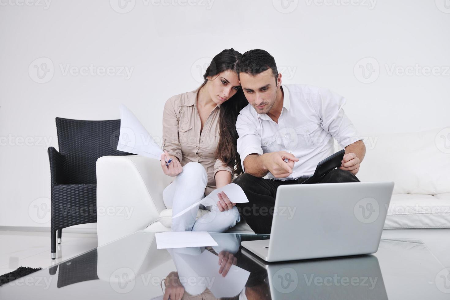 joyful couple relax and work on laptop computer at modern home photo
