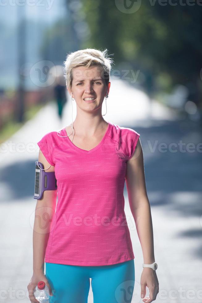 sporty woman running  on sidewalk photo