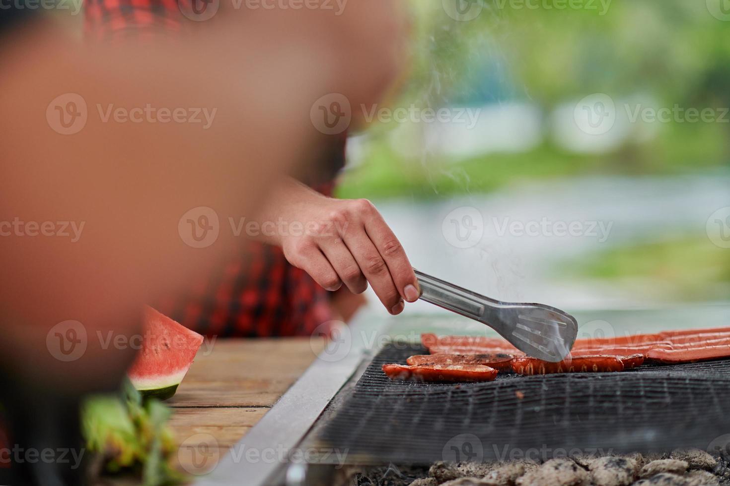 man cooking tasty food for french dinner party photo