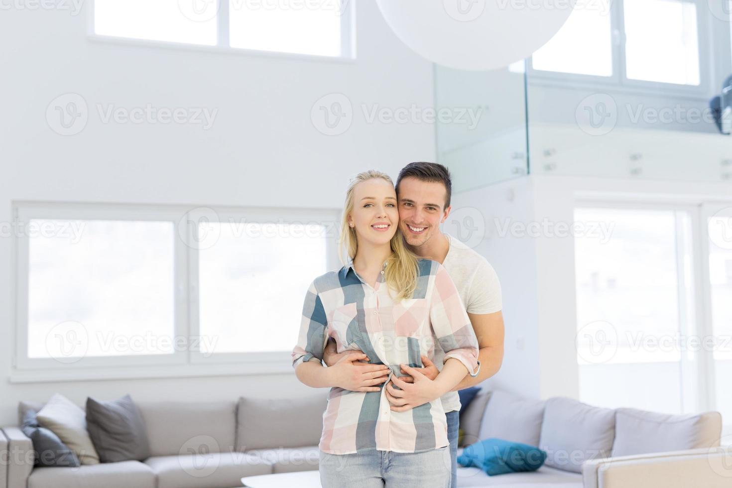 couple hugging in their new home photo