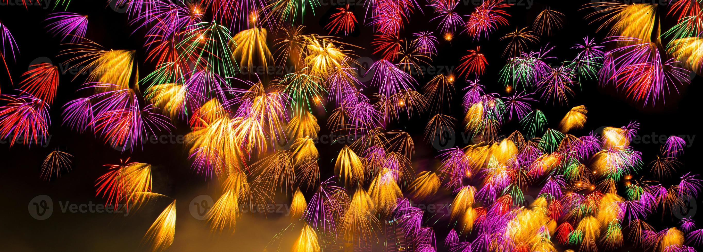 Colourful New Years Fireworks Display lighting up the night sky at  Chao Phraya river.  as New Year Day, Christmas eve, Independence Day 4th July or party event. isolated on black photo