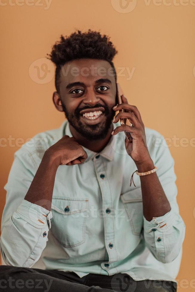 African student using laptop computer to study and make business connections yellow background photo