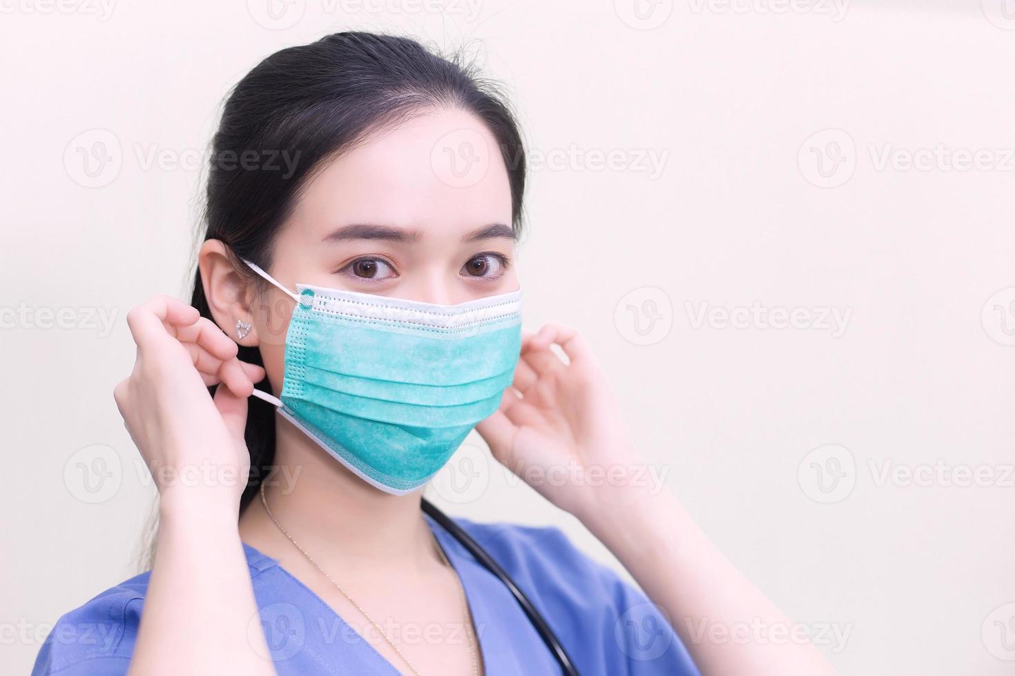 Asian female doctor is wearing medical  face masks to protect from Coronavirus-19 COVID-19 in healthcare and new normal concept. photo